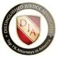 Badge for Distinguished Justice Advocates highlighting top one percent attorneys in America featuring a red and gold shield with initials and black circular border